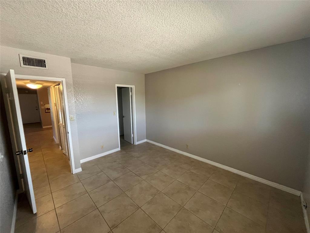 2020 Northeast 56th Street, Unit 208 Fort Lauderdale, FL 33308 - Photo 29 of 54 an empty room with mirror