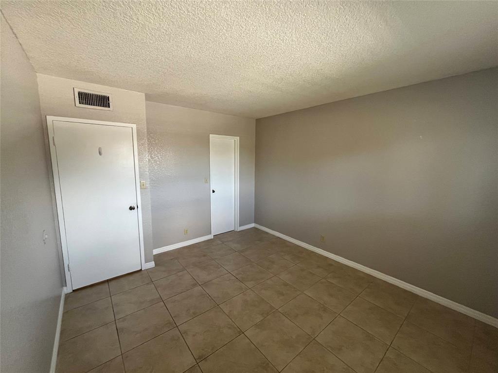 2020 Northeast 56th Street, Unit 208 Fort Lauderdale, FL 33308 - Photo 30 of 54 an empty room with a bench