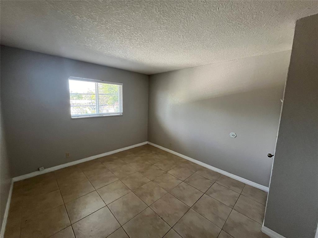 2020 Northeast 56th Street, Unit 208 Fort Lauderdale, FL 33308 - Photo 32 of 54 an empty room with windows