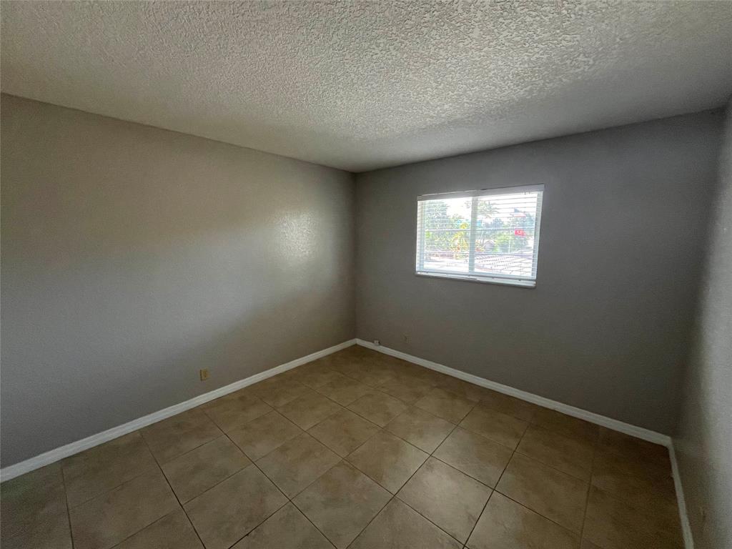 2020 Northeast 56th Street, Unit 208 Fort Lauderdale, FL 33308 - Photo 33 of 54 an empty room with windows