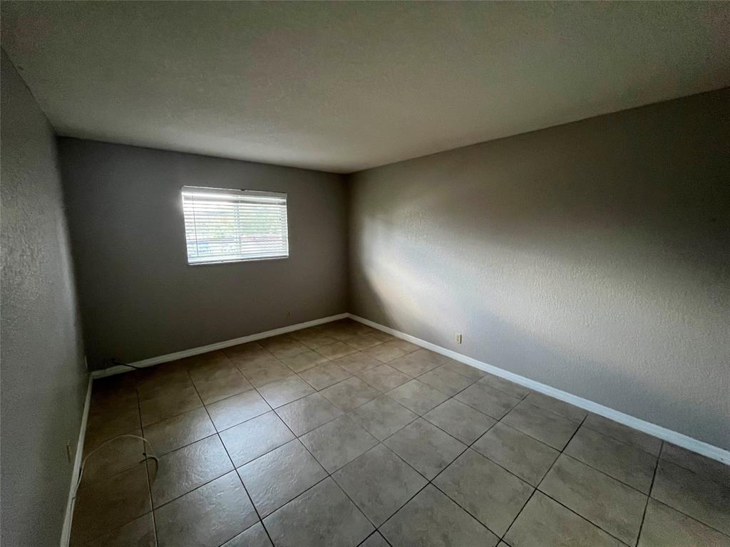 2020 Northeast 56th Street, Unit 208 Fort Lauderdale, FL 33308 - Photo 34 of 54 an empty room with windows
