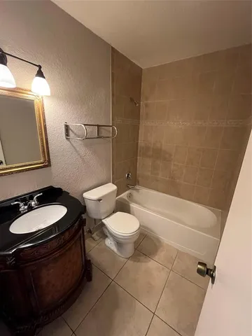 a bathroom with a toilet and a mirror