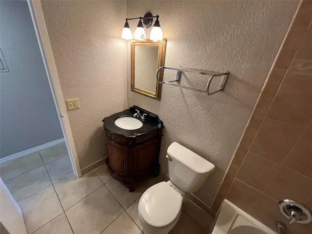 a bathroom with a toilet and a mirror