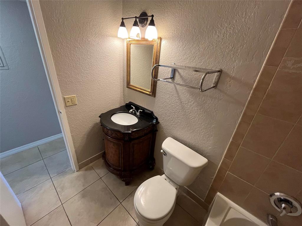 2020 Northeast 56th Street, Unit 208 Fort Lauderdale, FL 33308 - Photo 37 of 54 a bathroom with a toilet and a mirror
