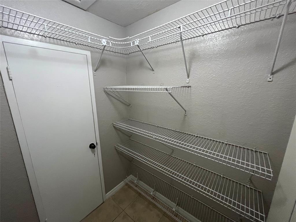 2020 Northeast 56th Street, Unit 208 Fort Lauderdale, FL 33308 - Photo 43 of 54 a view of a room with racks on the wall