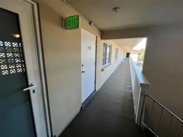 a view of a hallway with wooden stairs