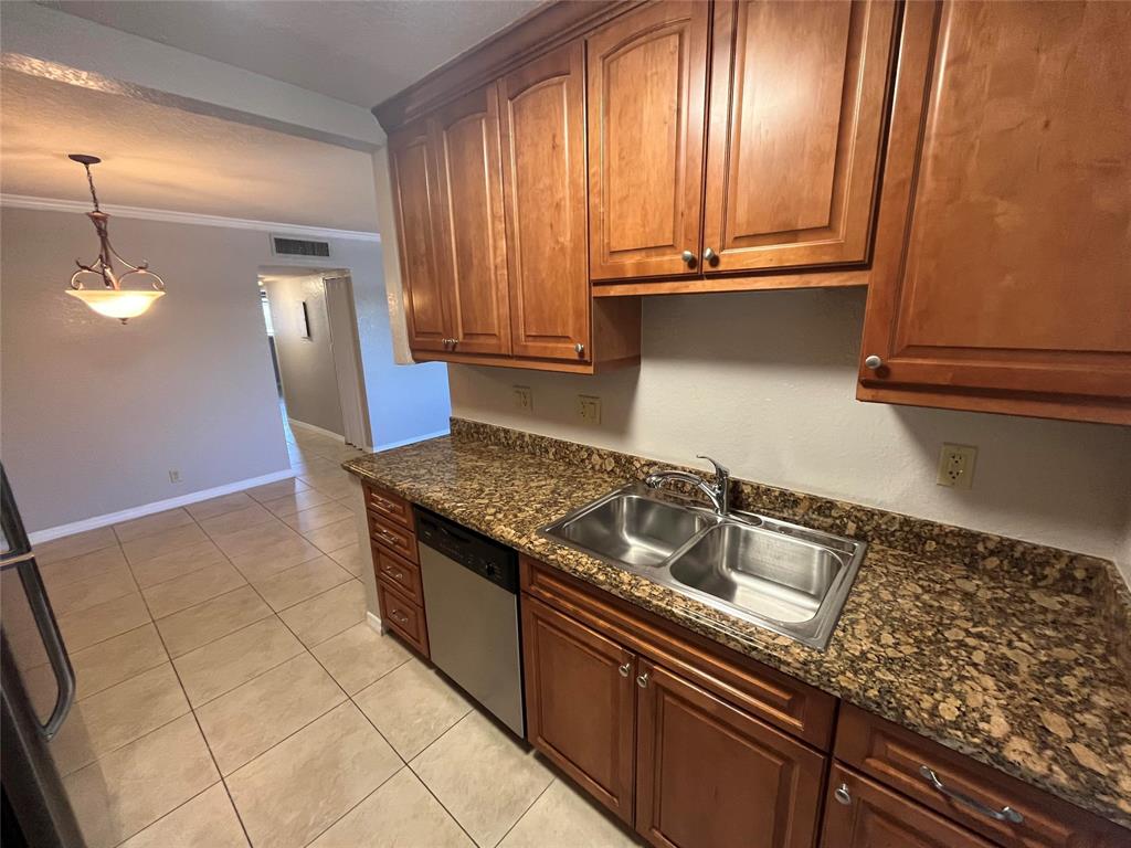 2020 Northeast 56th Street, Unit 208 Fort Lauderdale, FL 33308 - Photo 5 of 54 a kitchen with granite countertop a sink a stove and cabinets