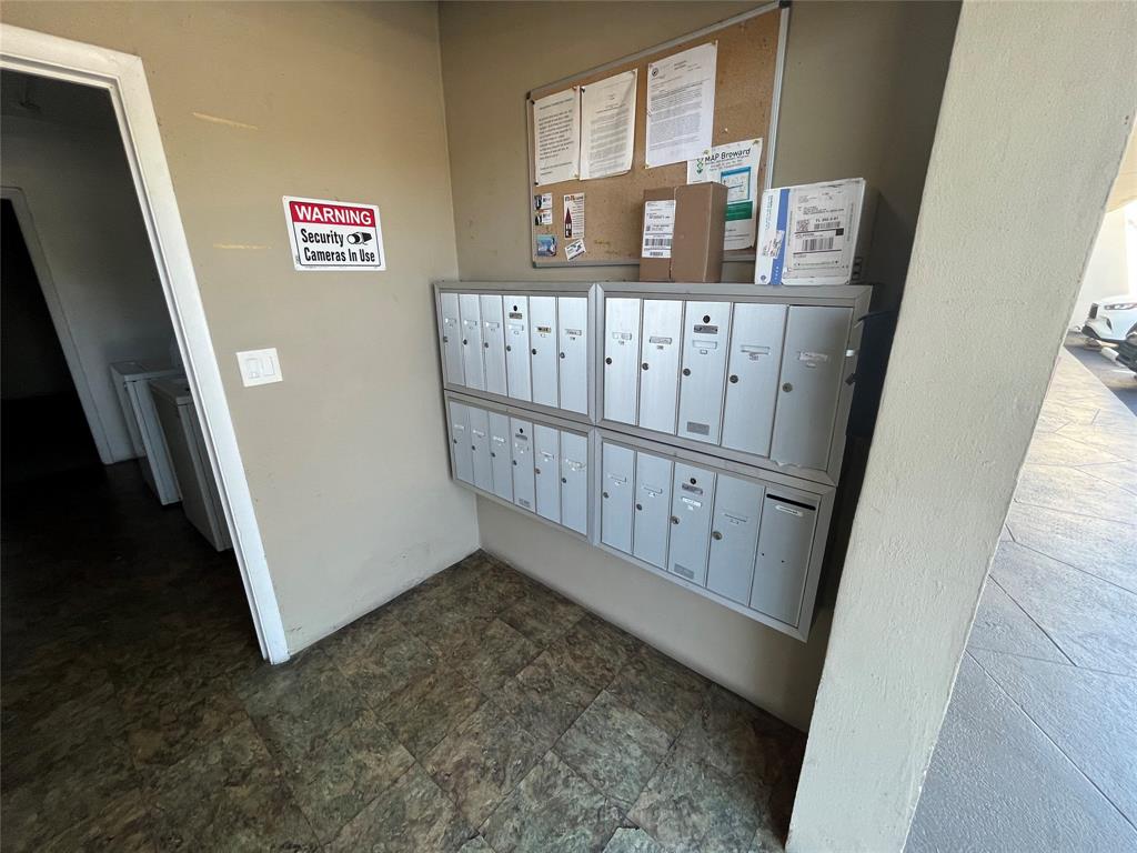 2020 Northeast 56th Street, Unit 208 Fort Lauderdale, FL 33308 - Photo 52 of 54 a view of a hallway with wooden stairs