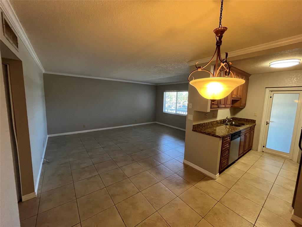 2020 Northeast 56th Street, Unit 208 Fort Lauderdale, FL 33308 - Photo 7 of 54 a kitchen with granite countertop a stove a sink a window and a counter top space