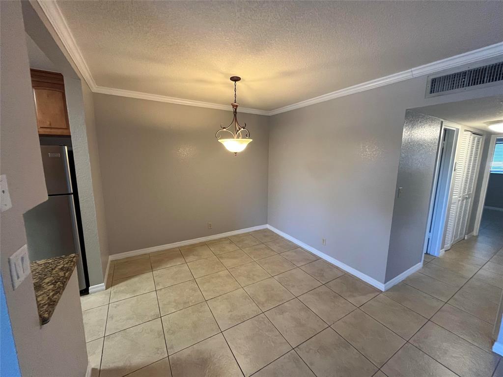 2020 Northeast 56th Street, Unit 208 Fort Lauderdale, FL 33308 - Photo 10 of 54 a view of an empty room with wooden floor and a window