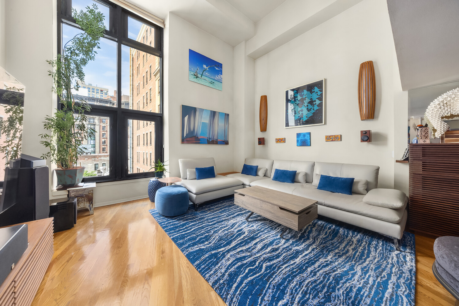 a living room with furniture a rug and a large window