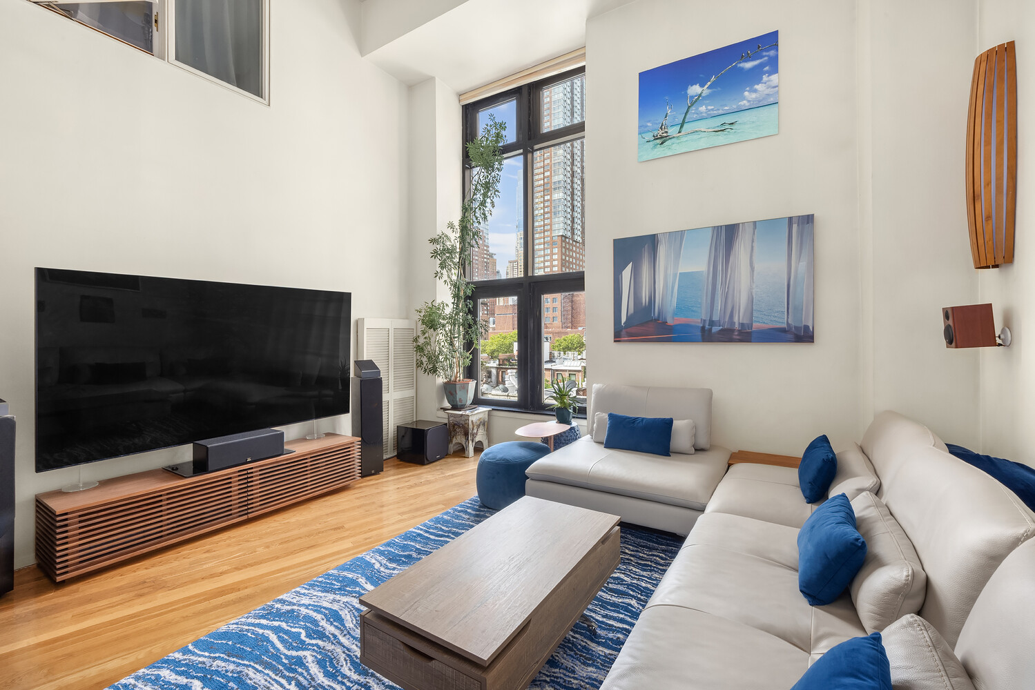 135 West 70th Street, Unit 6M Manhattan, NY 10023 - Photo 2 of 11 a living room with furniture and a flat screen tv