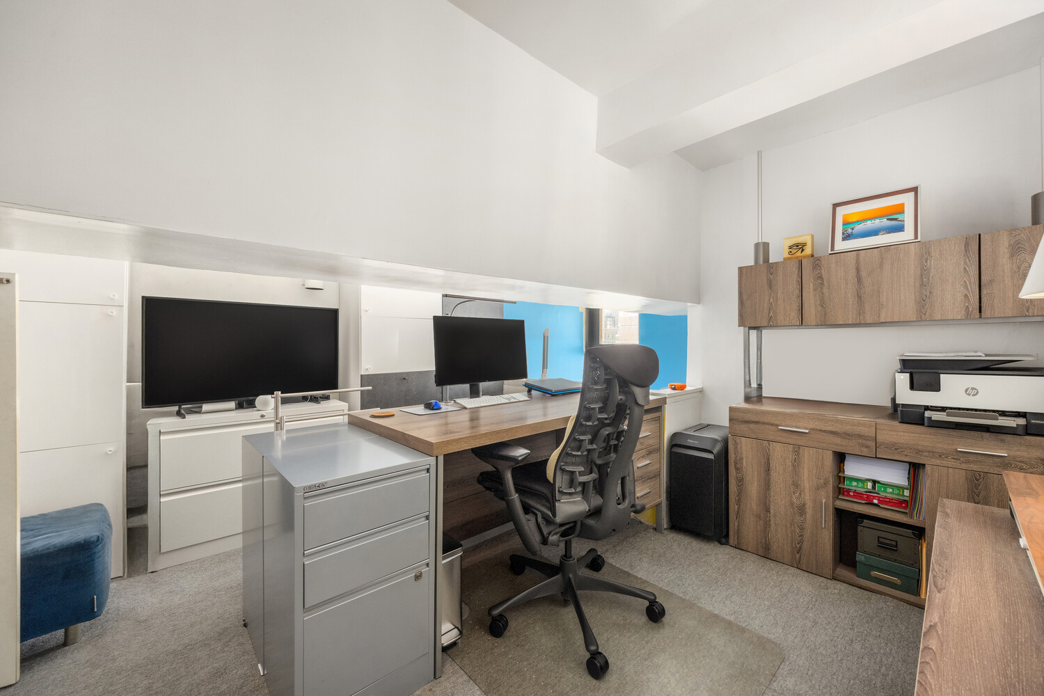 135 West 70th Street, Unit 6M Manhattan, NY 10023 - Photo 4 of 11 a view of a workspace with furniture and a flat screen tv