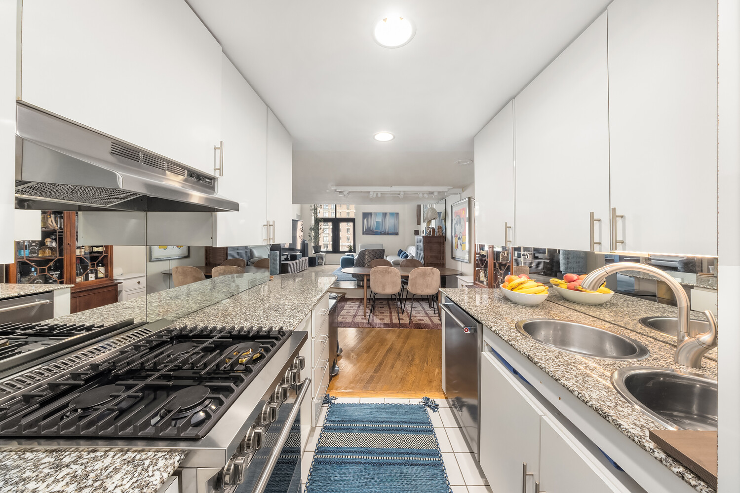 135 West 70th Street, Unit 6M Manhattan, NY 10023 - Photo 5 of 11 a kitchen with stainless steel appliances granite countertop a sink stove and refrigerator