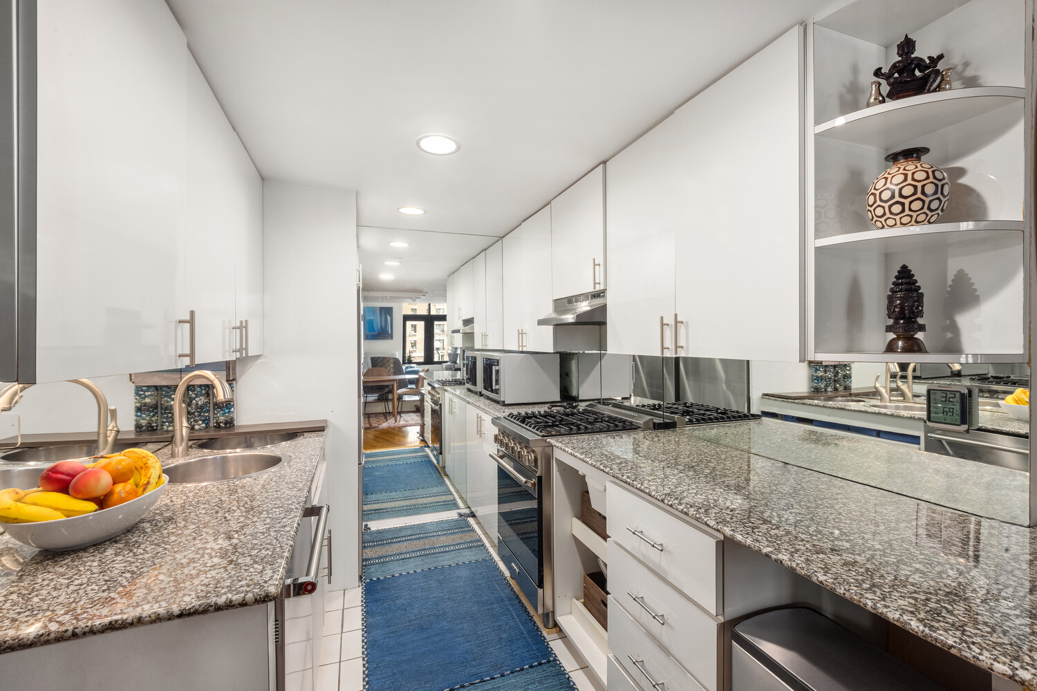 135 West 70th Street, Unit 6M Manhattan, NY 10023 - Photo 6 of 11 a kitchen with stainless steel appliances granite countertop sink stove and refrigerator
