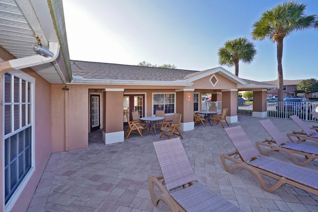 a view of a house with backyard porch and sitting area