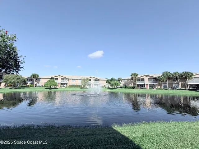 a view of a lake with houses in the background