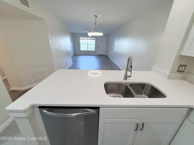 a kitchen with a sink and a refrigerator