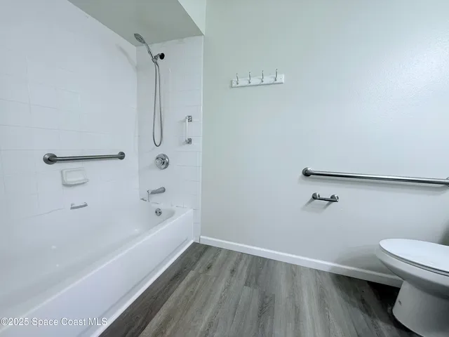 a bathroom with a bathtub and a toilet