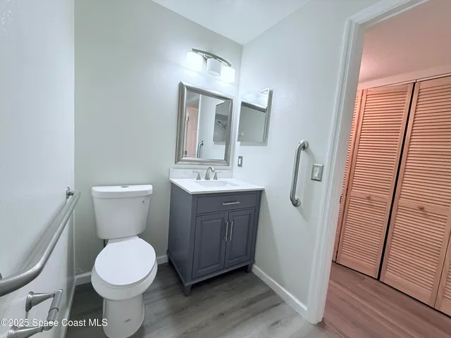 a bathroom with a toilet sink and a mirror