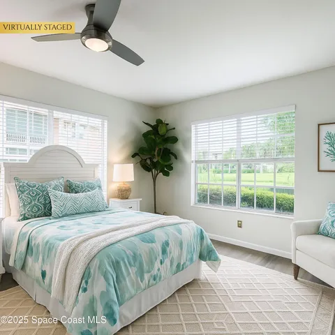 a bedroom with a large bed and a large window
