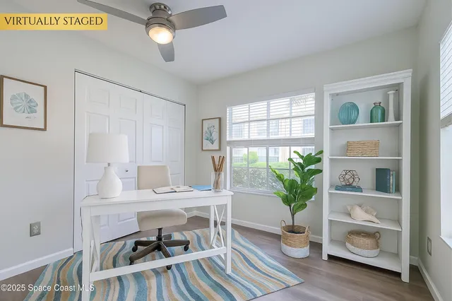 a view of a workspace with furniture and a potted plant