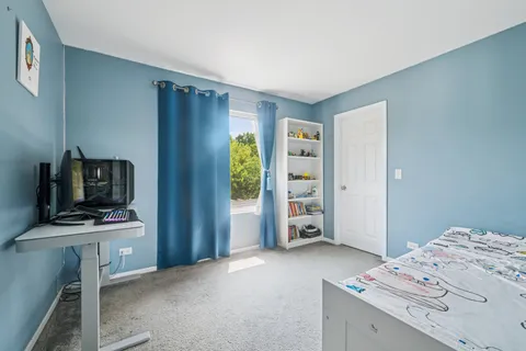 a bedroom with a bed and a television