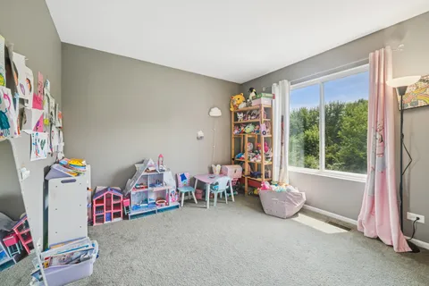 a living room with furniture a flat screen tv and a large window