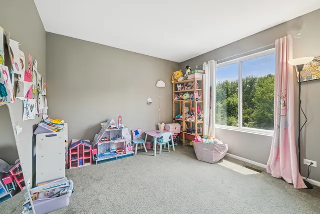 a living room with furniture a flat screen tv and a large window