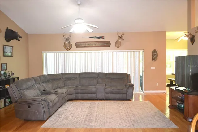 a living room with furniture window and a flat screen tv
