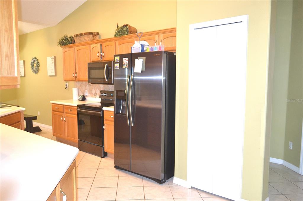 400 South Co Road 115 Bunnell, FL 32110 - Photo 15 of 26 a kitchen with stainless steel appliances a refrigerator and a sink