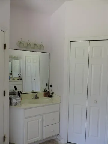 a bathroom with a sink and vanity