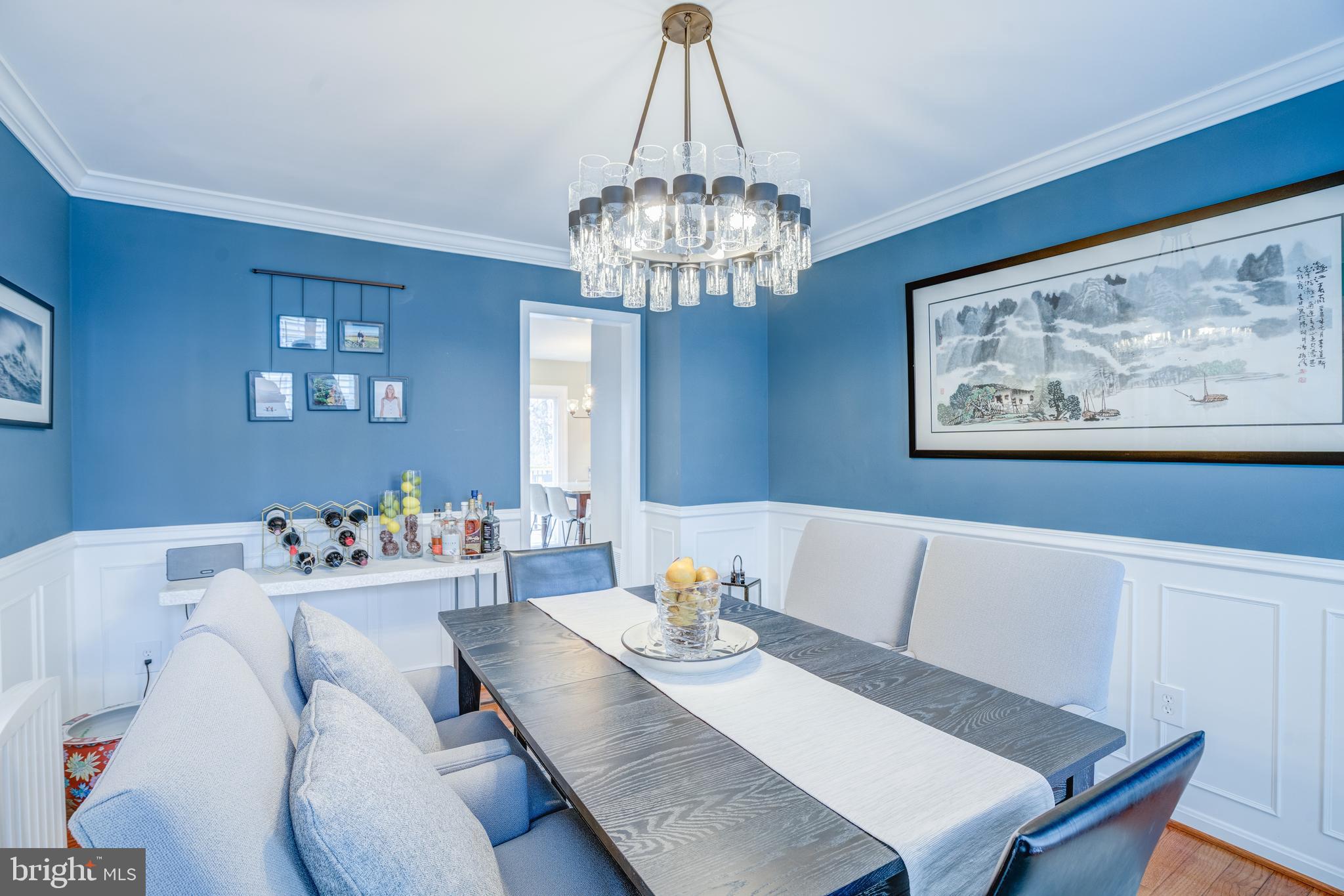 8529 High Timber Court Ellicott City, MD 21043 - Photo 11 of 94 a view of a dining room with furniture a chandelier and wooden floor