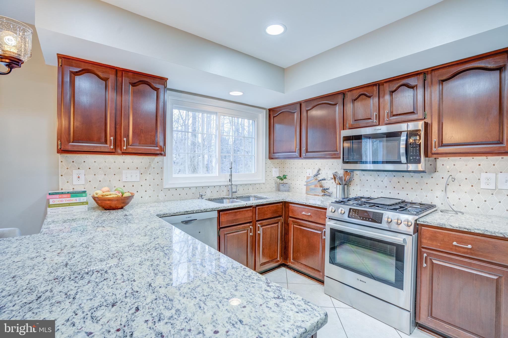 8529 High Timber Court Ellicott City, MD 21043 - Photo 24 of 94 a kitchen with stainless steel appliances granite countertop a stove sink and cabinets