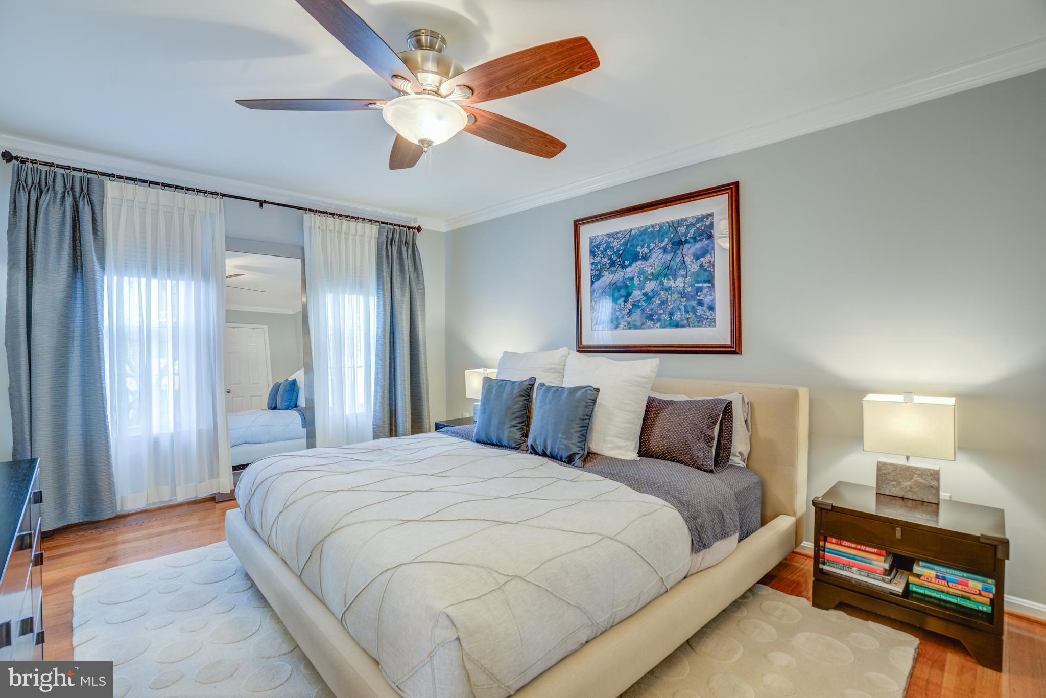 8529 High Timber Court Ellicott City, MD 21043 - Photo 33 of 94 a bedroom with a large bed and a chandelier