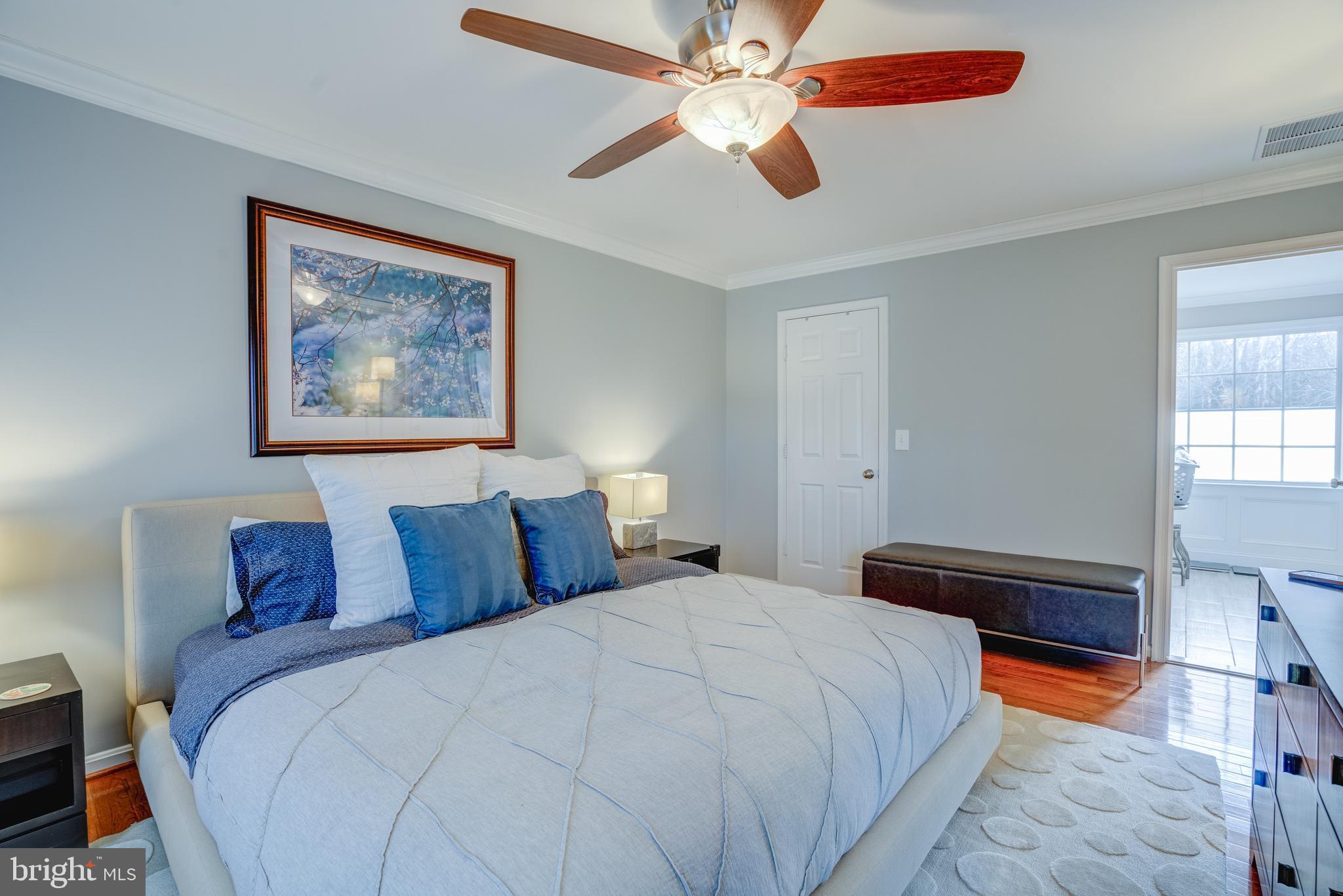 8529 High Timber Court Ellicott City, MD 21043 - Photo 35 of 94 a bedroom with a bed and a chandelier