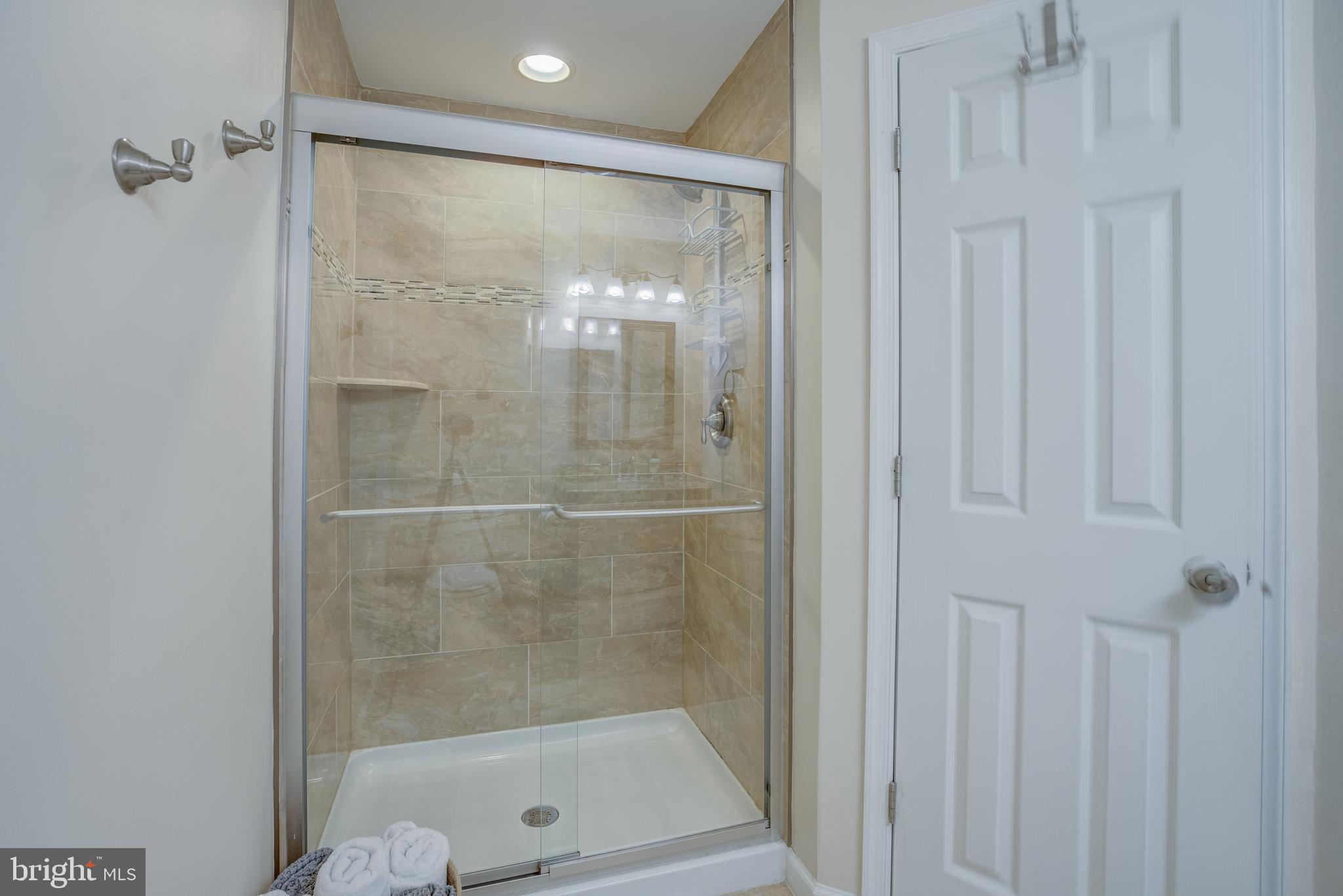 8529 High Timber Court Ellicott City, MD 21043 - Photo 73 of 94 a bathroom with a glass shower door
