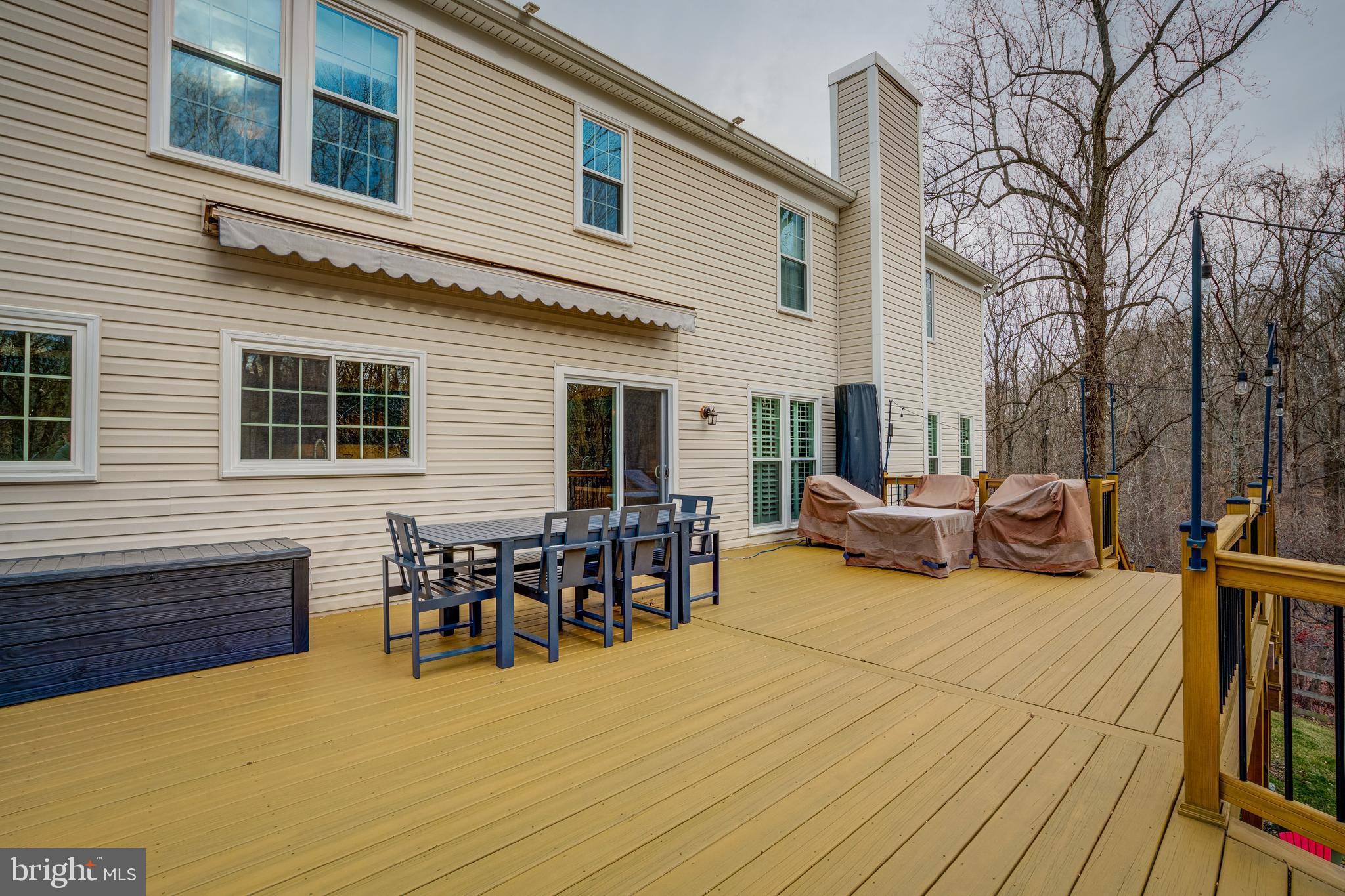 8529 High Timber Court Ellicott City, MD 21043 - Photo 82 of 94 a view of a patio with table and chairs and wooden floor
