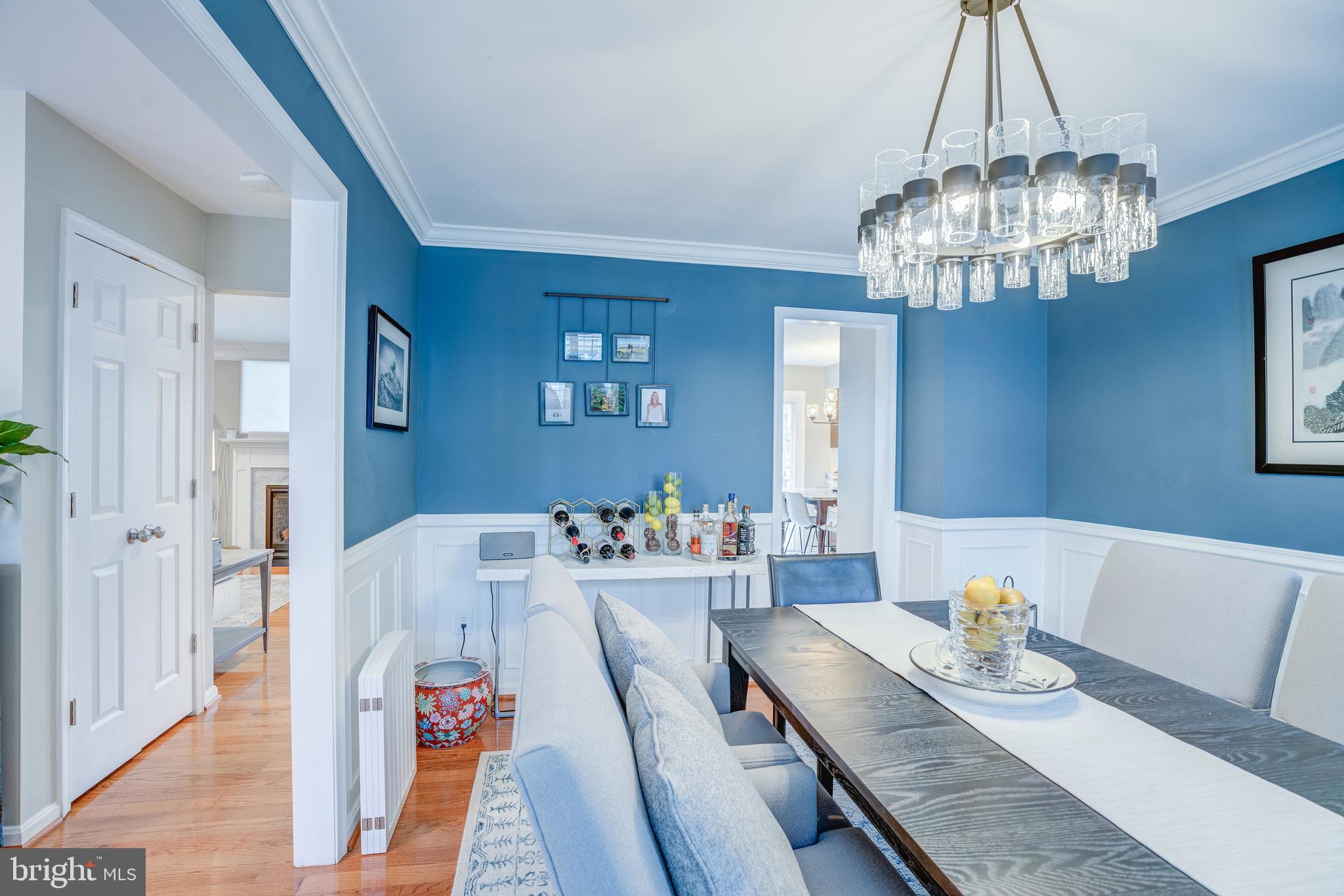 8529 High Timber Court Ellicott City, MD 21043 - Photo 10 of 94 a view of a dining room with furniture a chandelier and wooden floor
