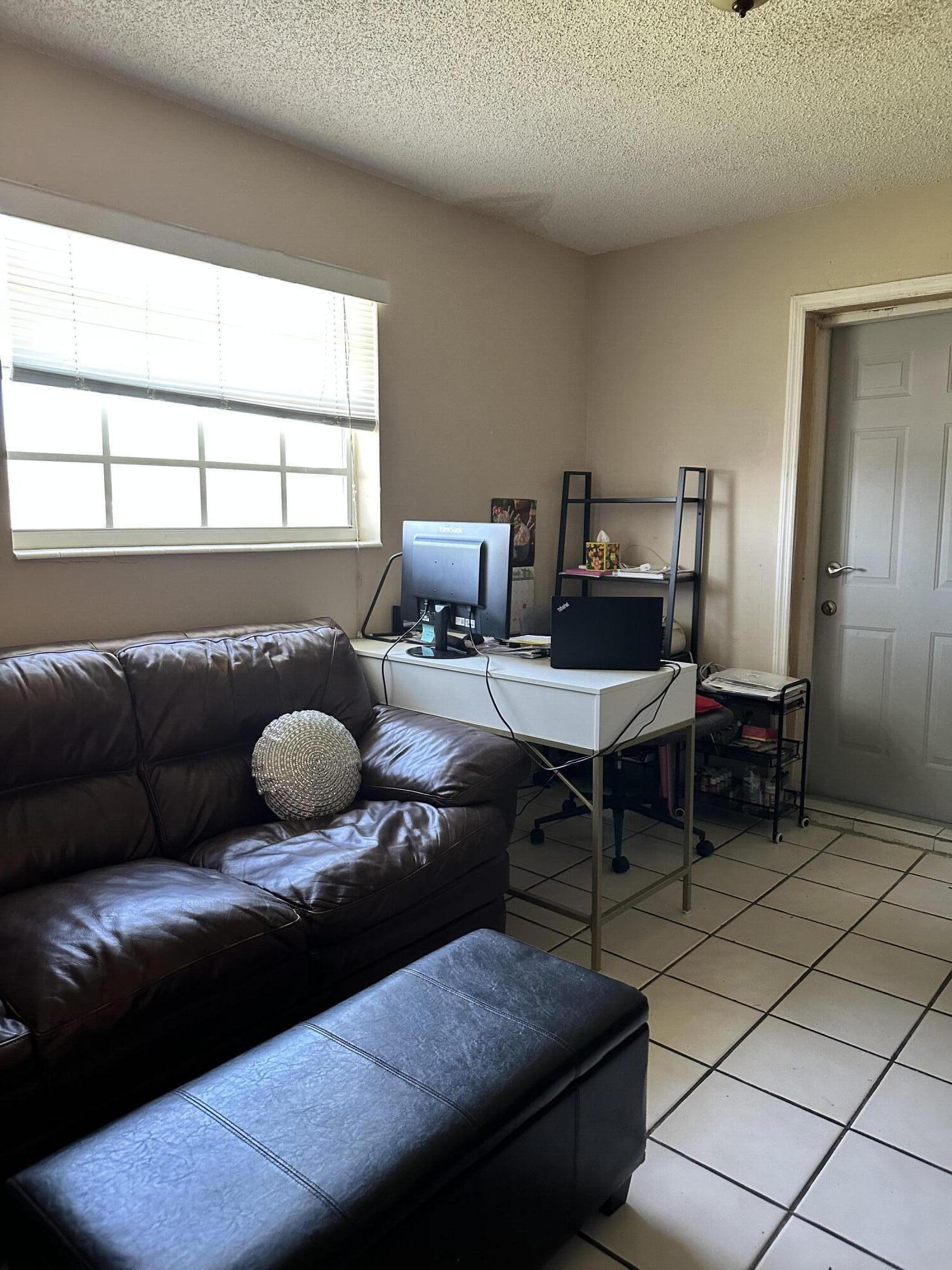 7960 Northwest 174th Street Hialeah, FL 33015 - Photo 16 of 22 a living room with furniture and a window