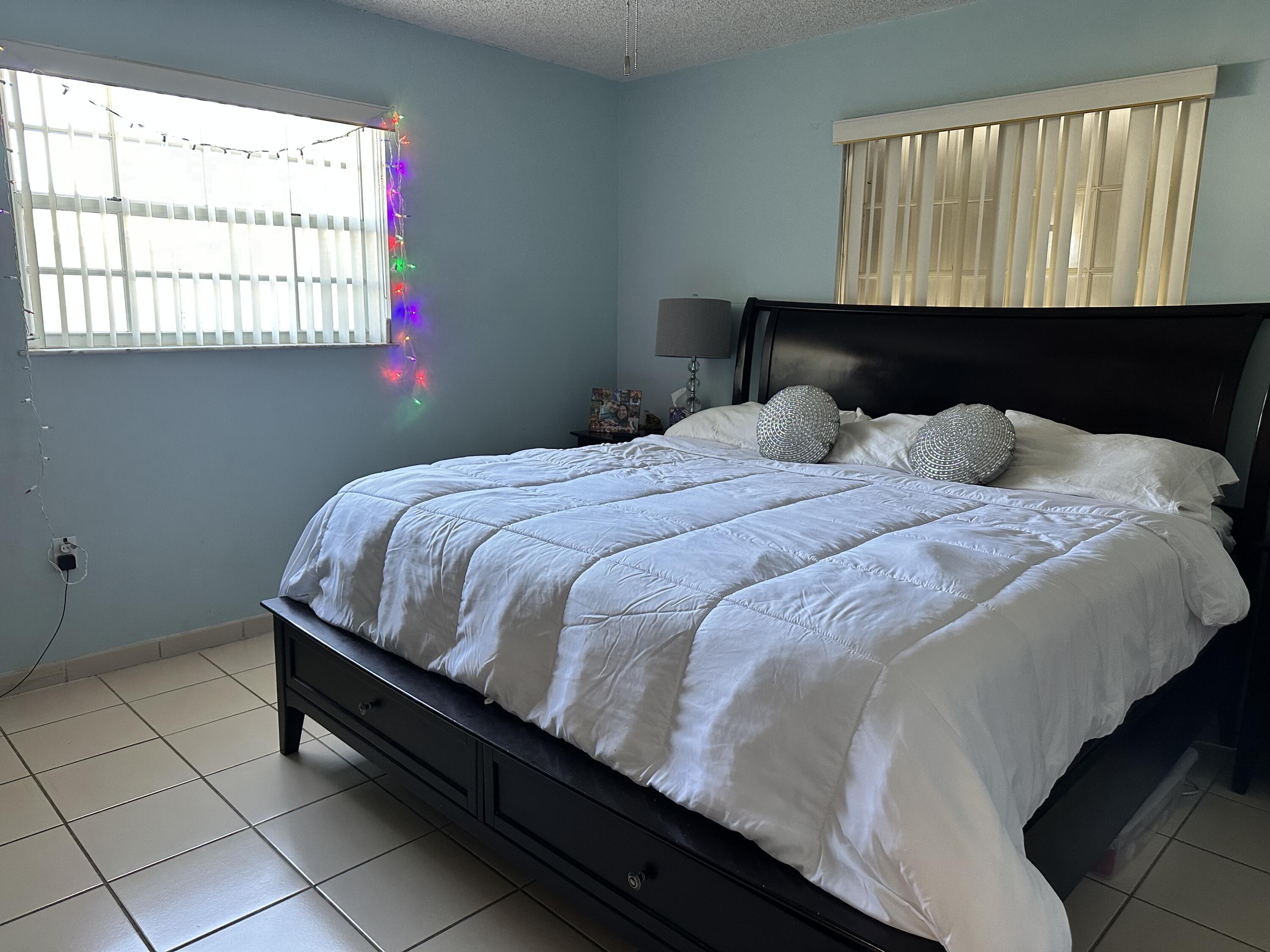7960 Northwest 174th Street Hialeah, FL 33015 - Photo 17 of 22 a bedroom with a bed and window