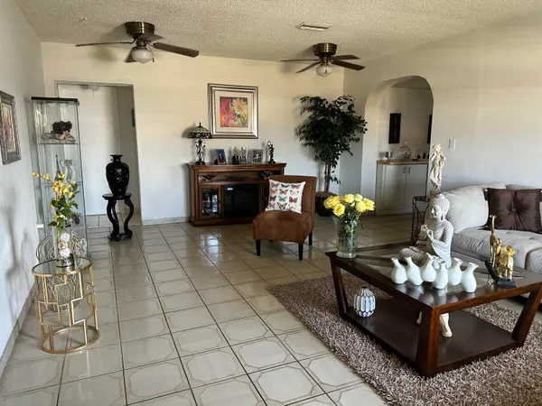 a living room with furniture flowerpot and a fireplace