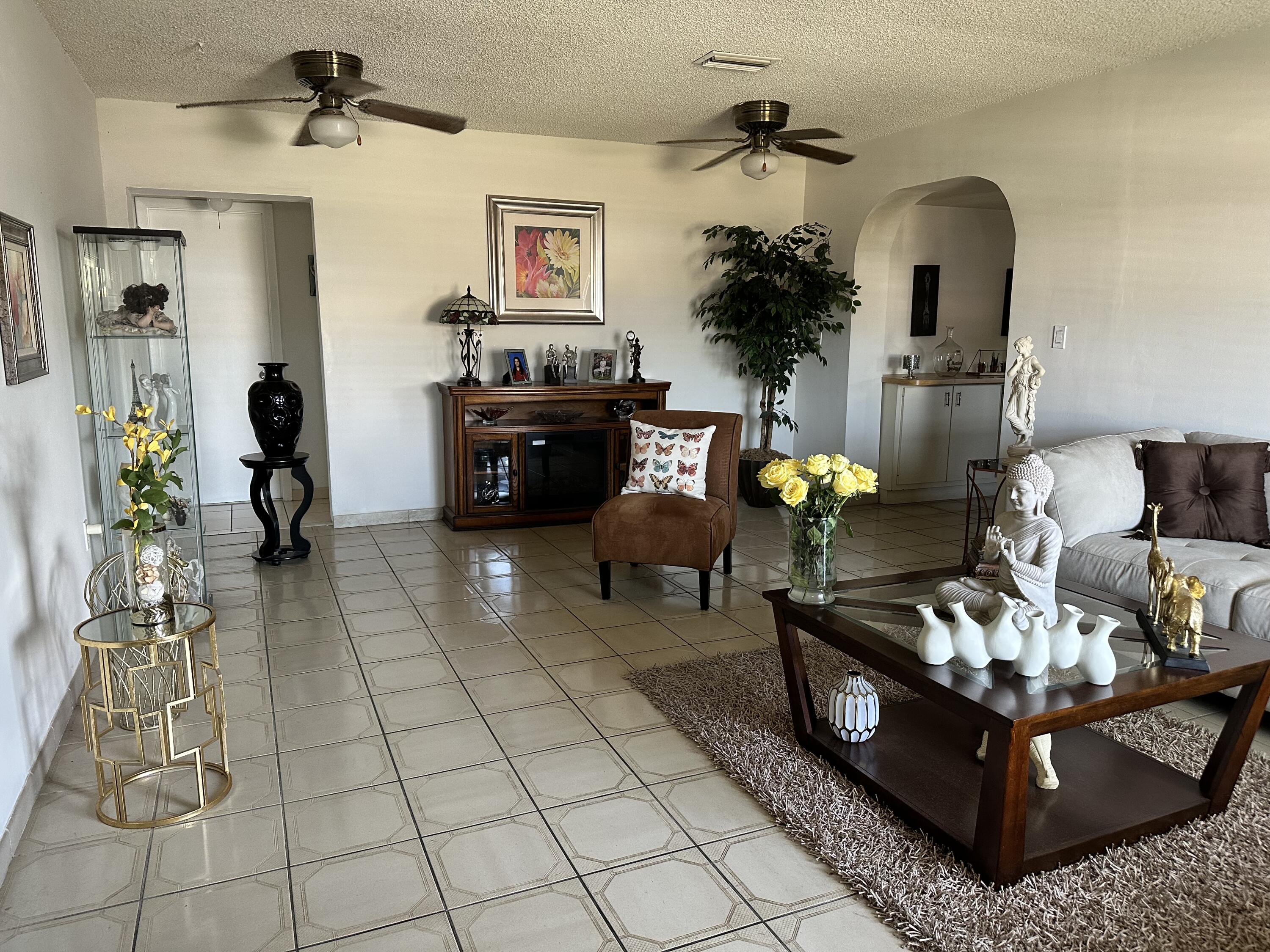 7960 Northwest 174th Street Hialeah, FL 33015 - Photo 3 of 22 a living room with furniture flowerpot and a fireplace