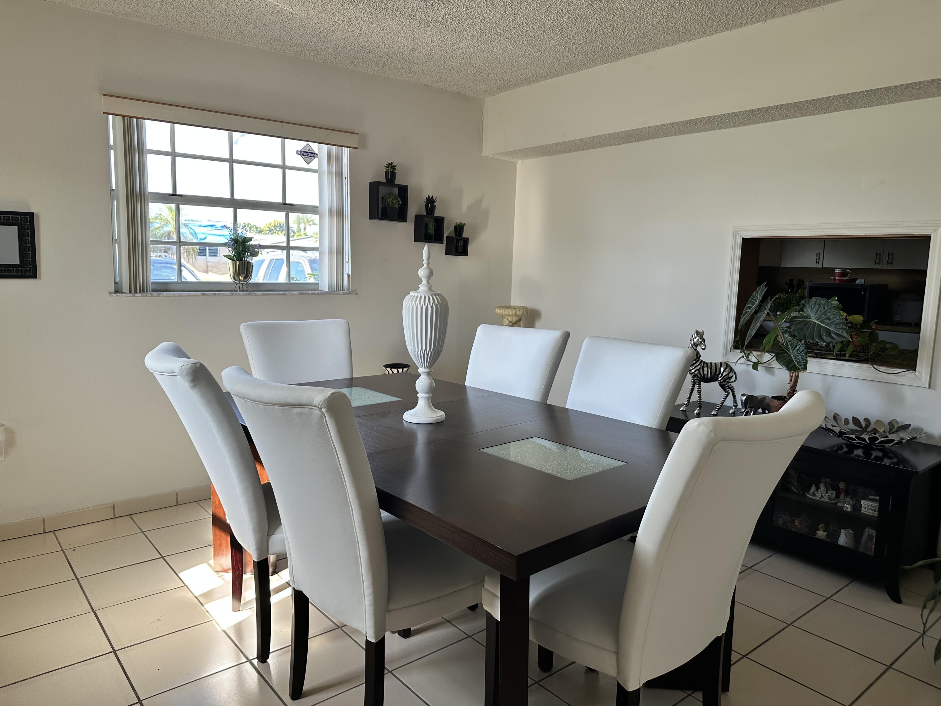 7960 Northwest 174th Street Hialeah, FL 33015 - Photo 10 of 22 a view of a dining room with furniture and window