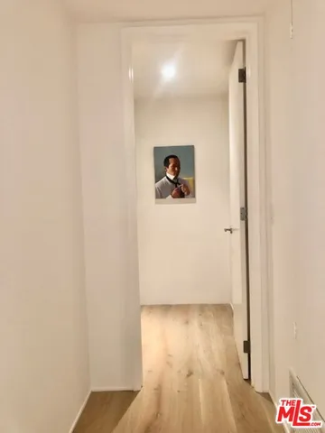 a view of a room with wooden floor and furniture