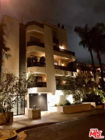 a view of a patio with a table and chairs under an umbrella
