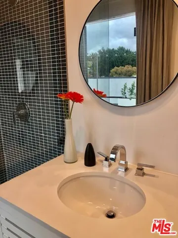 a spacious bathroom with a double vanity sink and a mirror