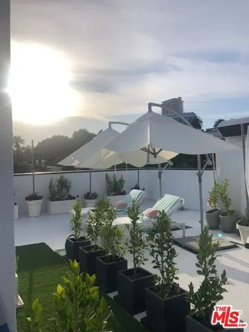 a dining room with furniture and a flat screen tv