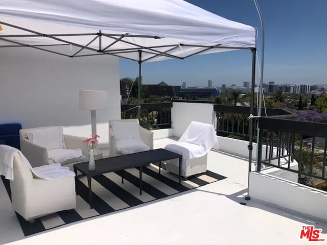 a view of a room with a table and chairs