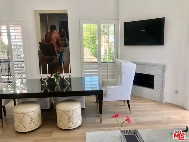 a living room with a floor to ceiling window and an outdoor space